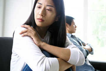 Fototapeta premium The woman felt depressed, upset and sad after fighting with her husband's bad behavior. Unhappy young wife bored with problems after marriage.