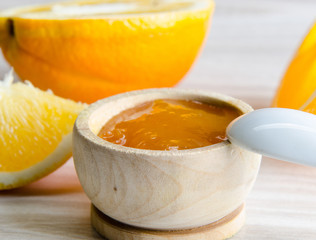 Orange jam served in spoon on the table