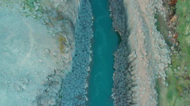 Aerial top view over Stu&eth;lagil Canyon, East Iceland. Impressive landscape with Basalts Colums in  Glacier Valley, crystal clear water of Glacial River. daylight and tourists in The Valley J&ouml;kuldalur.