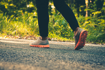 Close up foot women run feet on road in workout wellness.