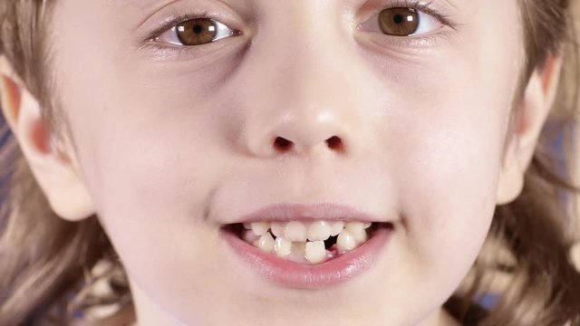 Smiling boy of six years breaths through the mouth. Closeup