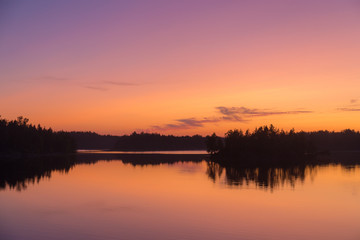 Fototapeta na wymiar dramatic twilight on a forest lake