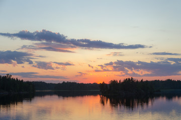 Fototapeta na wymiar forest lake at dramatic sunset