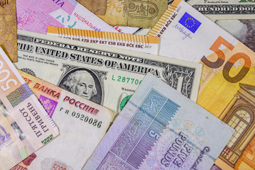 Multi currency background. Euro, american dollars, ukrainian hryvnias, egyptian pounds, russian roubles