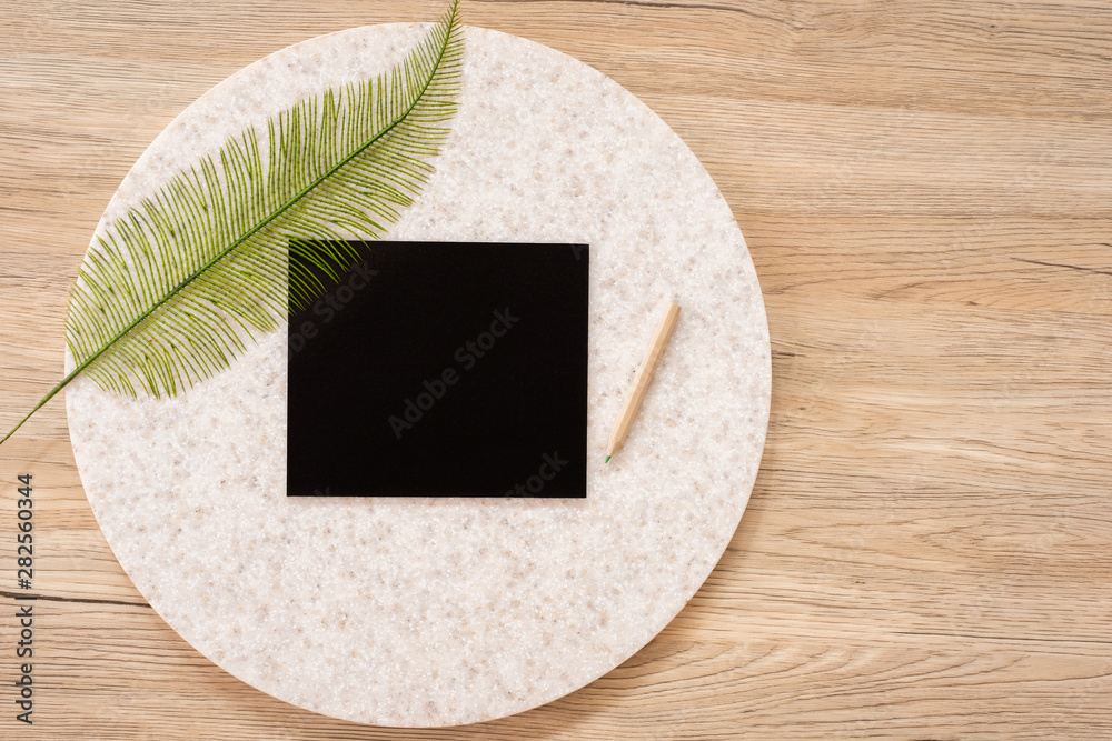 Poster top view of blank blackboard with leaf and pencil on wooden table with copy space.eco sustainable co