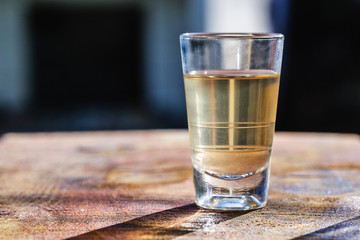 Several glasses of brazilian cachaça isolated on rustic wooden background, variations and types of brazil cachaça, typical drink from brazil.