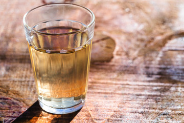 Several glasses of brazilian cachaça isolated on rustic wooden background, variations and types of brazil cachaça, typical drink from brazil.