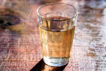Several glasses of brazilian cachaça isolated on rustic wooden background, variations and types of brazil cachaça, typical drink from brazil.