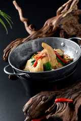 Fried thousand pages tofu with pepper in a black dry pot
