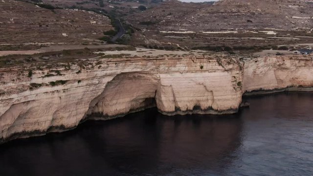 Aerial Shot flying towards a small Cave in Dingli Cliffs