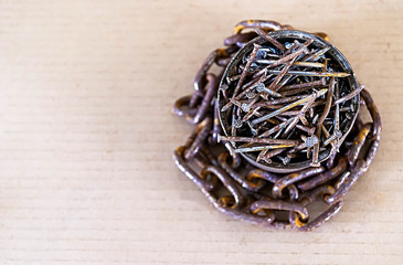Fototapeta premium many rusty nails and rusty chain, close-up