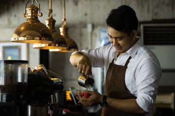 Happy Asian barista man working in cafe, lifestyle concept.