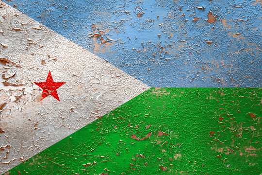 National flag of Djibouti on old peeling wall background.The concept of national pride and symbol of the country.