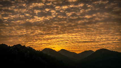 Amazing clouds with silhouette and foggy mountains at sunset. Kumlubuk, Marmaris, Turkey.