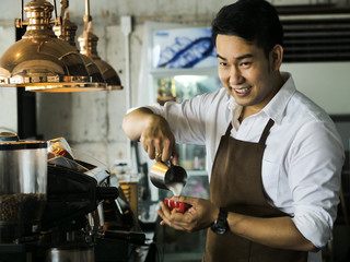 Happy Asian barista man working in cafe, lifestyle concept.
