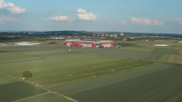 Drone / Aerial shot of the football stadium of the bundesliga team FSV Mainz 05 with field in the foreground on a sunny day, 25p