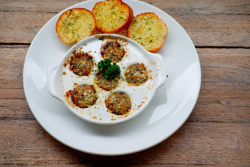 baby clam on wood table