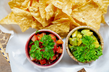 nachos with avocado sauce on wood table