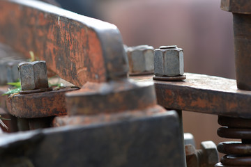Old rusty nuts and bolt joint on fragment of partially old machine