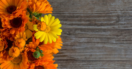 bouquet of calendula on an old wooden background with copy space top view