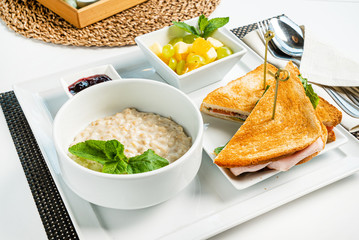 breakfast in the cafe with oatmeal and sandwich