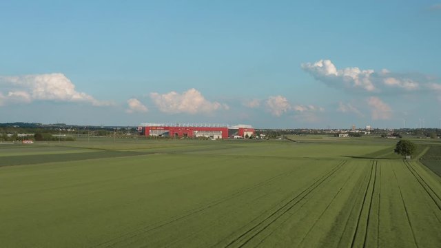 Drone / Aerial shot of the football stadium of the bundesliga team FSV Mainz 05 with field in the foreground on a sunny day, 25p