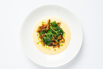 polenta with chanterelles on the white plate