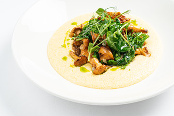 polenta with chanterelles on the white plate