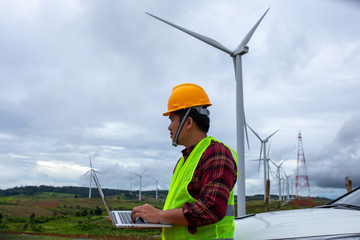 Engineering windmill use the laptop checking windy