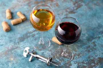 Glasses of white and red wine. The concept of winemaking. Place under your text. Still life on a textural background.