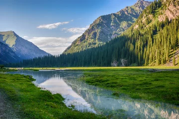 Fotobehang Idyllic summer landscape with hiking trail in the mountains with beautiful fresh green mountain pastures, river with reflection and forest. Terskey Alatoo mountains, Tian-Shan, Karakol, Kyrgyzstan © sergfear