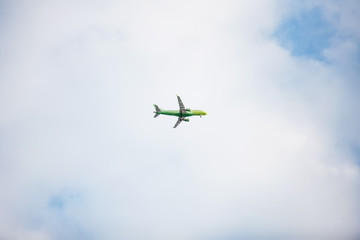 Airplane in the blue cloudy sky