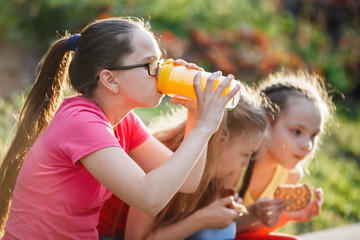 Naklejka premium Teenager girl drinks from glass.