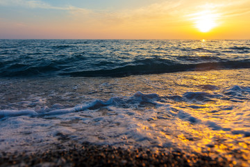 Fototapeta na wymiar Waves on the seashore at sunset