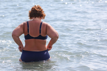Fat woman by the sea