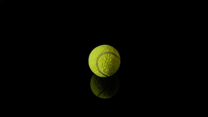 1 one green tennis ball isolated in black with reflection below it
