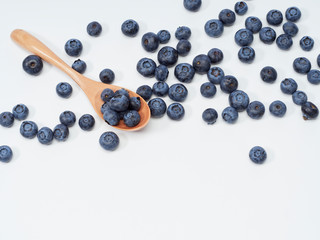 Blueberry fruit vitamins in a wooden spoon
