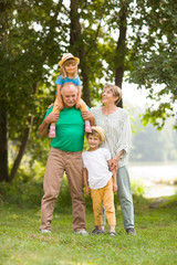 Grandparents and grandsons in summer outdoors. Concept of friendly family.
