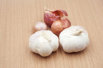 garlic and onion on wooden floor
