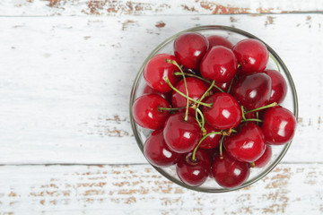 A small glass bowl with ripe fresh cherry	