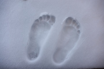 two bare foot on the fresh white snow