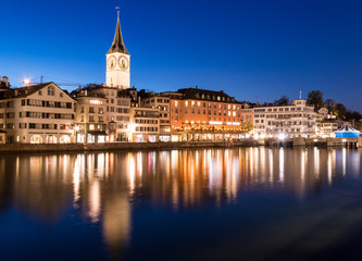 Fototapeta na wymiar Zurich skyline with St. Peter church along the Limmat river during twilight