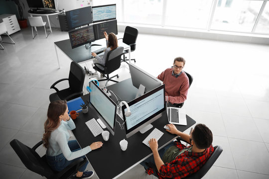 Team of programmers working in office