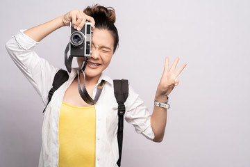 Happy woman take a photo by camera isolated over background