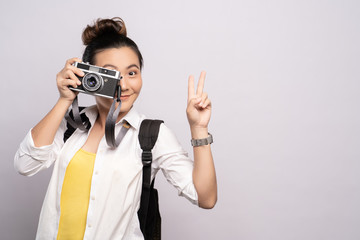 Happy woman take a photo by camera isolated over background