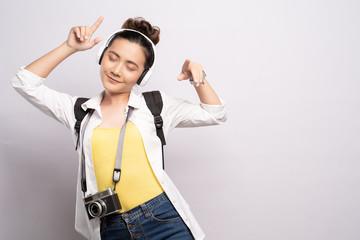 Tourist woman listening music isolated over white background