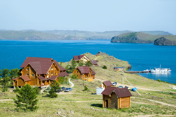 Beautiful view of the tourist center on the shore of Lake Baikal. Far left - Olkhon island....