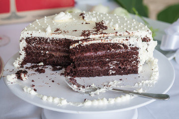 The wedding cake is cut into pieces.