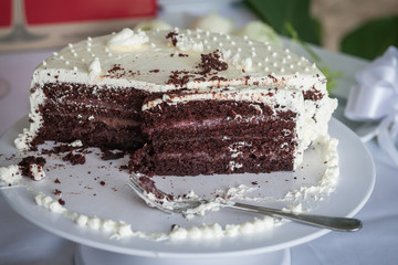 The wedding cake is cut into pieces.
