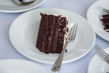 The wedding cake is cut into pieces.